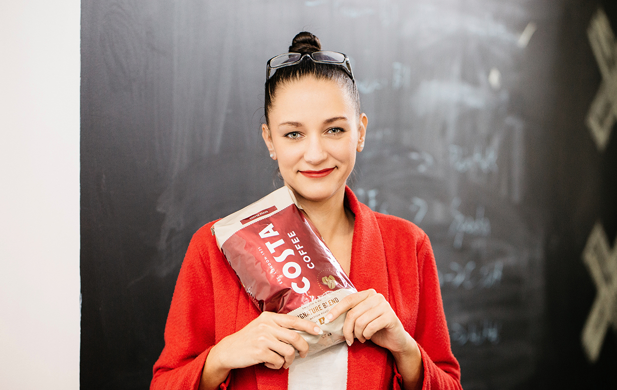 Employee Holding a Costa Coffee Packet
