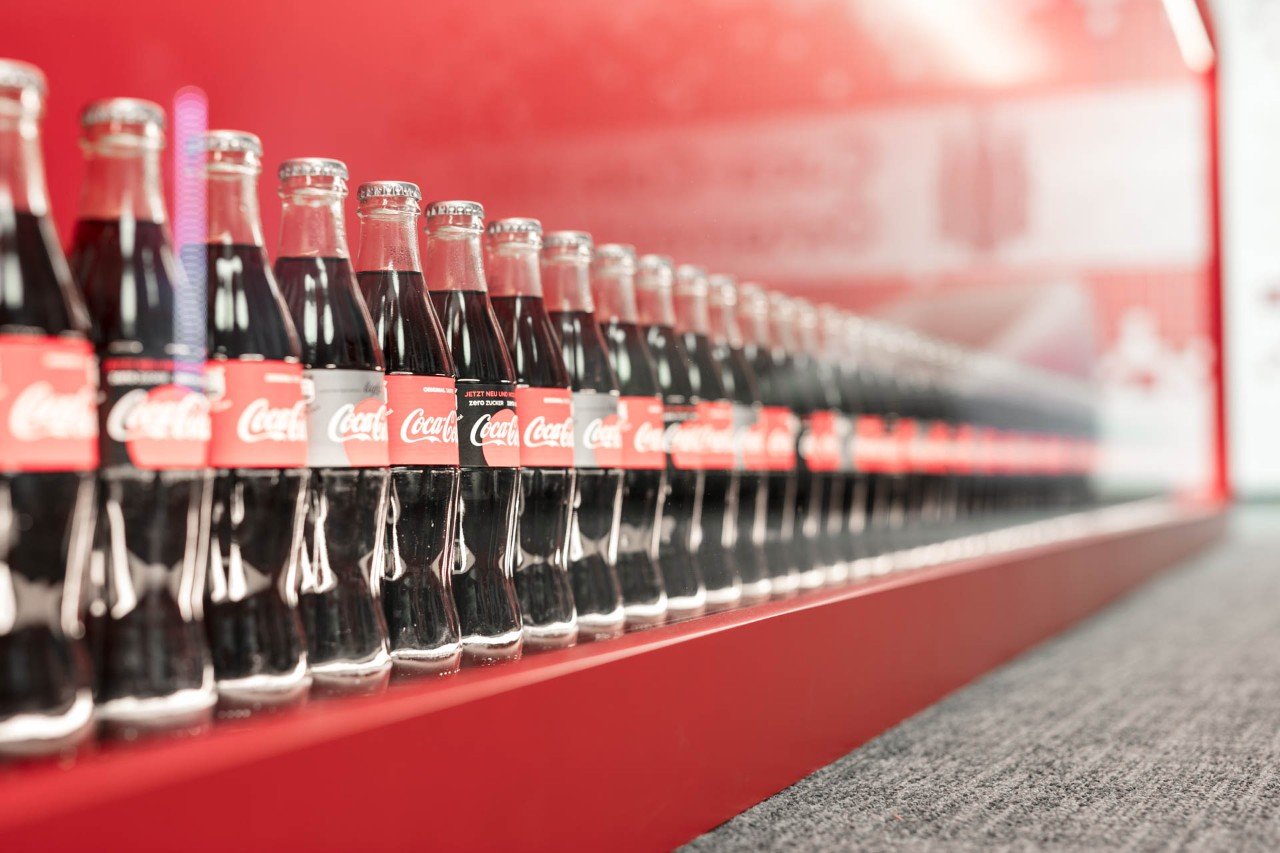 Coca-Cola 0.33 glass bottles lined up one after the other